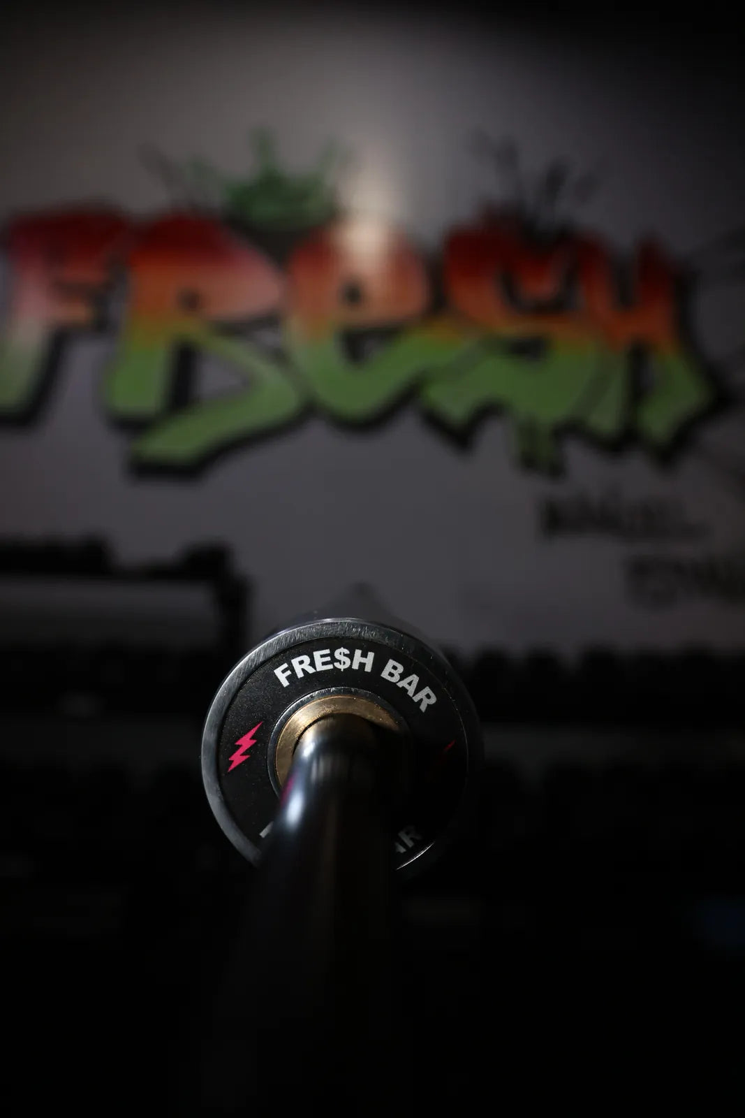 Fresh Bar: The Fresh Bar end cap, red bolts, in front of the FRESH mural at SPS Fit, seen from the floor.