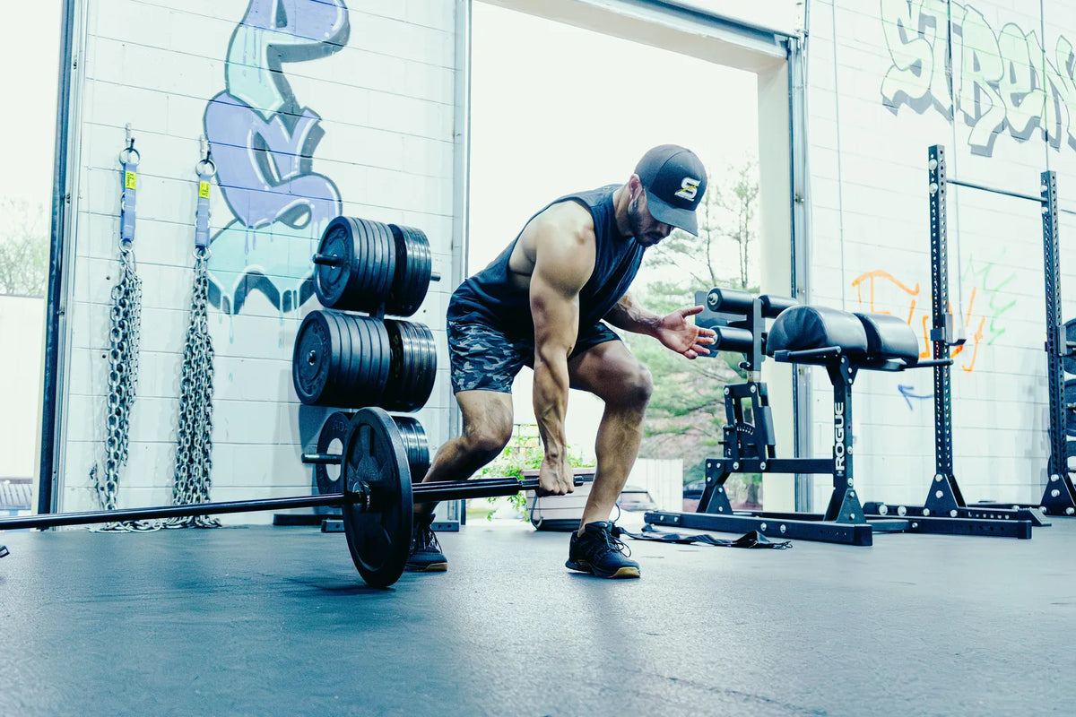 Spann Bar: An athlete setting up a single-arm landmine deadlift with the loaded Spann Bar.